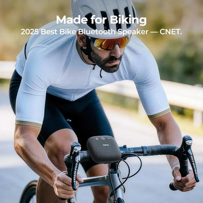 Gray textured tribit stormbox micro 2 bluetooth speaker mounted on bicycle handlebars for outdoor activities ip67 waterproof