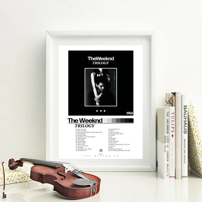 White-framed trilogy the weeknd album poster with black and white wall art featuring tracklist on clean white background