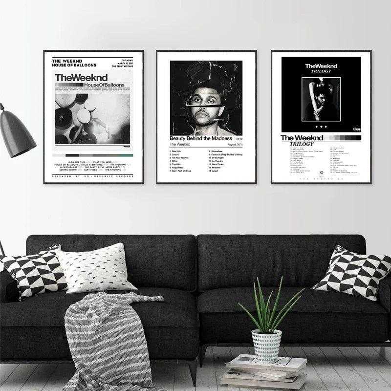 Three framed black and white trilogy the weeknd album wall art posters mounted above a dark sofa for home decor