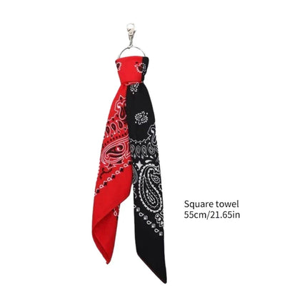 Red and black paisley bandana-style cashew print square scarf tied as a necktie for trousers chains hip use
