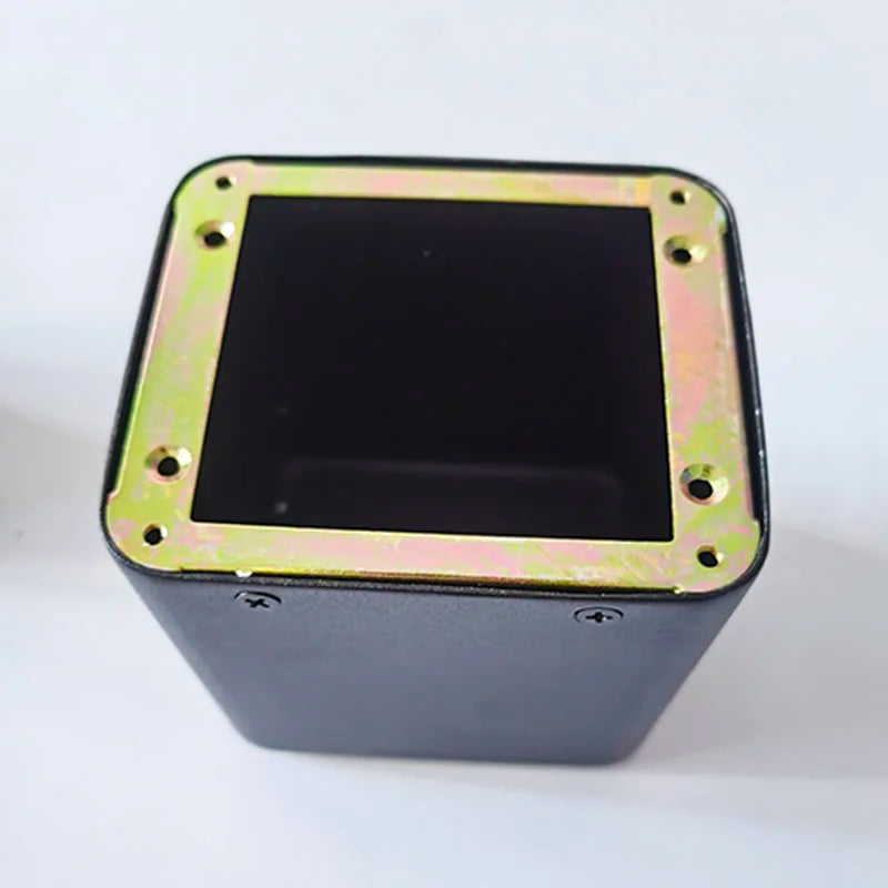 Black rectangular tube amplifier case with gold metal base transformer cover and isolation shrouds secured by four screws