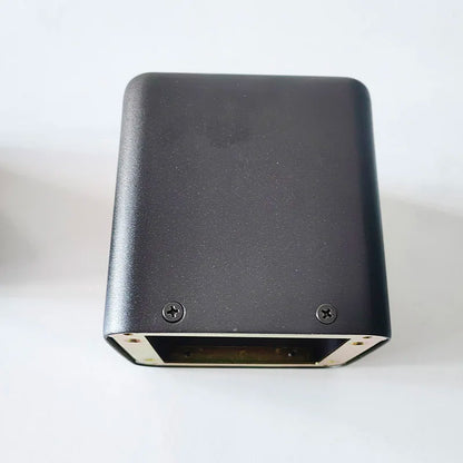 Black rectangular tube amplifier case with matte finish and two screws on bottom edge showing base transformer cover isolation shrouds