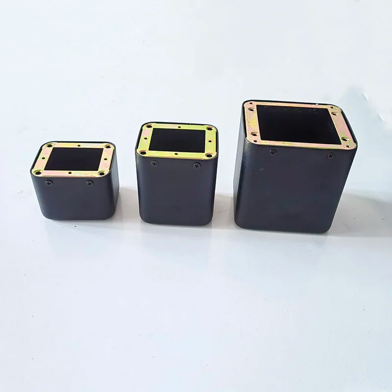 Three black tube amplifier cases with gold metal edges and base transformer cover isolation shrouds in ascending sizes