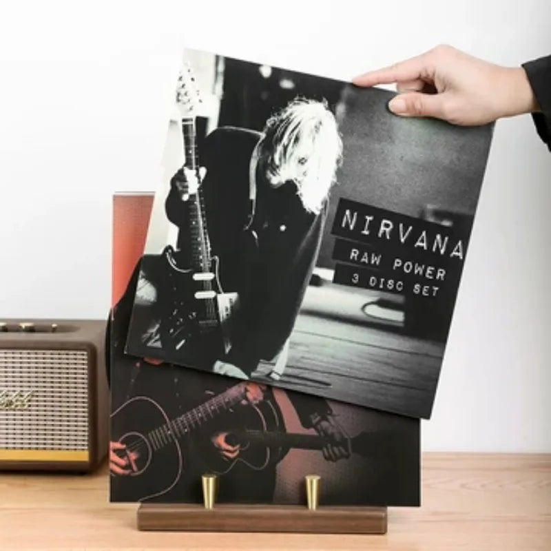Black and white nirvana raw power vinyl album displayed on a wooden media console turntable stand for music lover decor