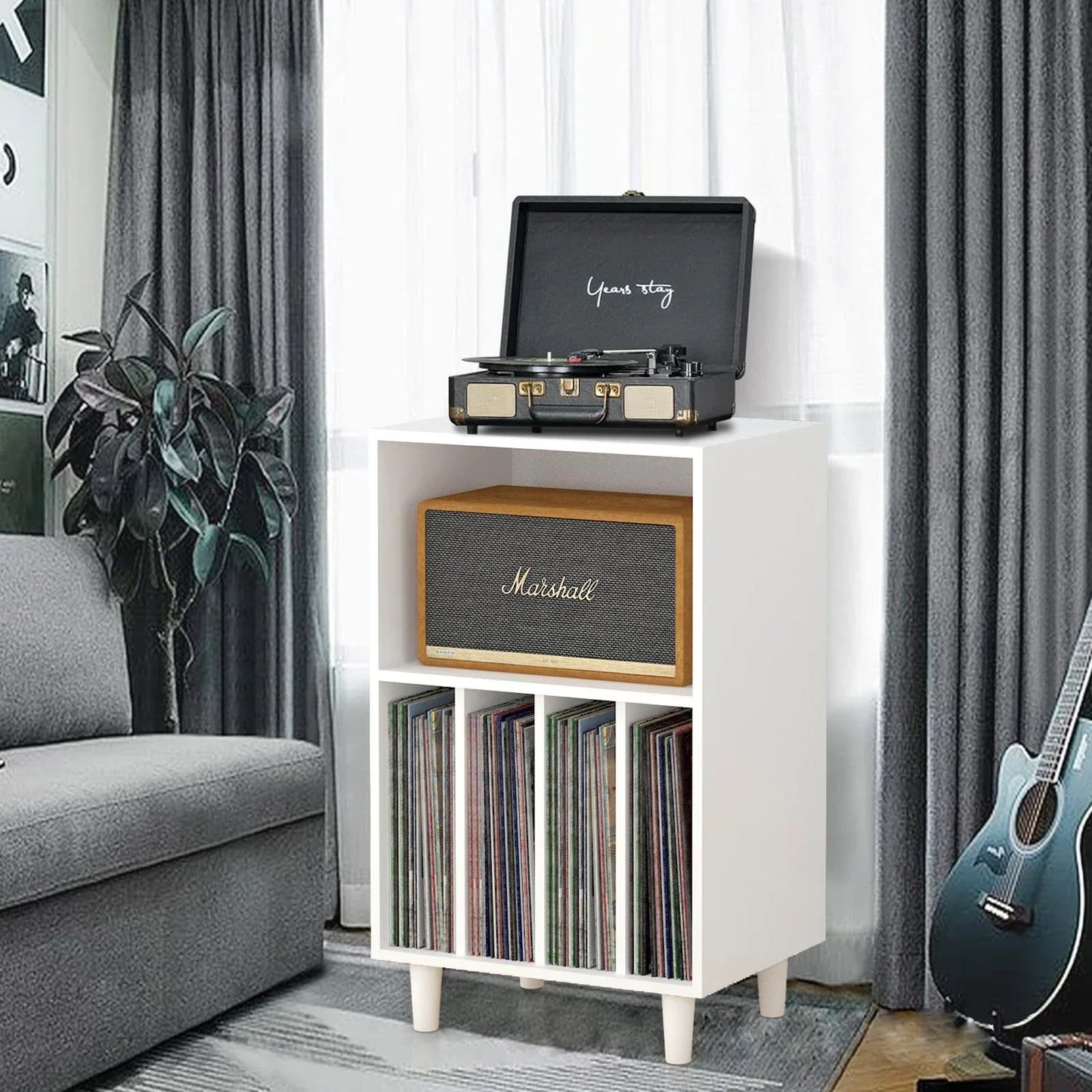 White wooden media console turntable stand with open cube shelves holding vinyl records and marshall speaker for music lover decor