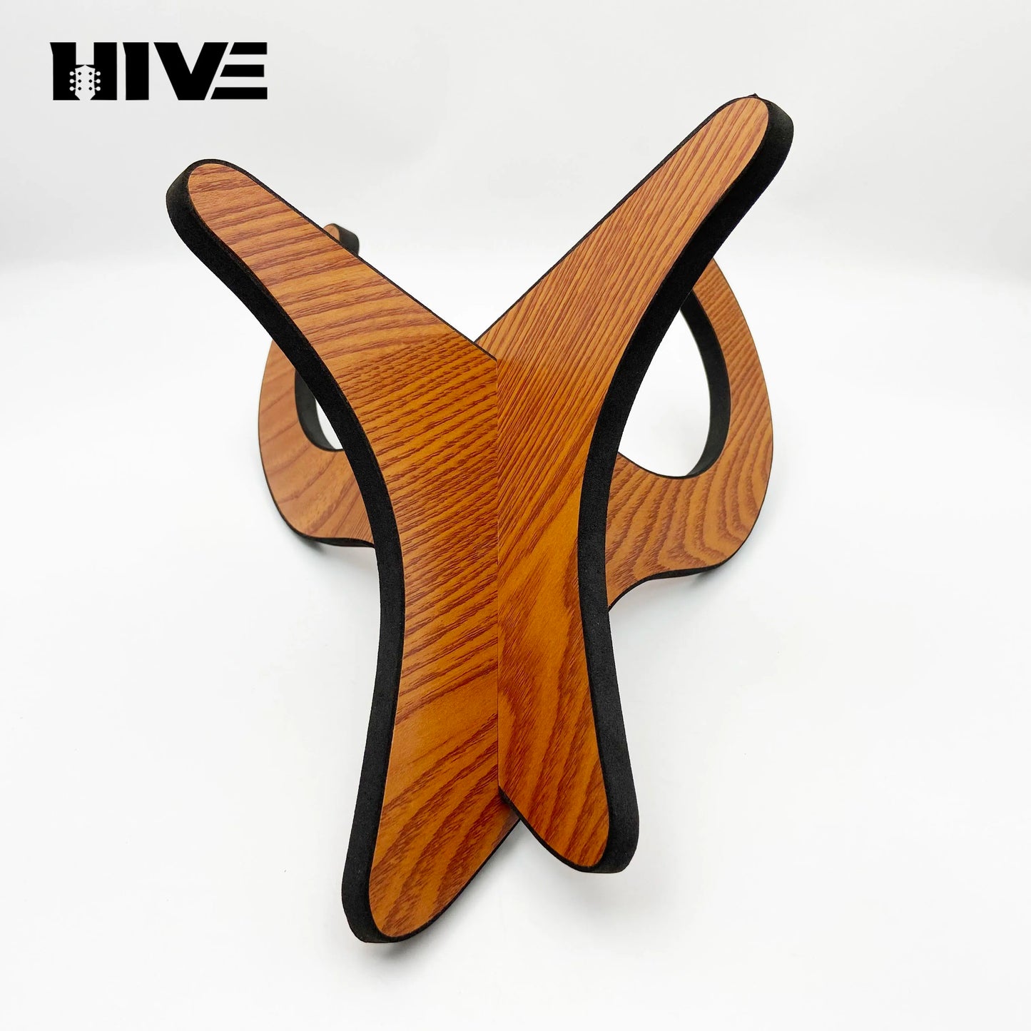 Hive brand ukulele stand wooden with warm brown wood grain finish and black edge trim for guitar folding upright use