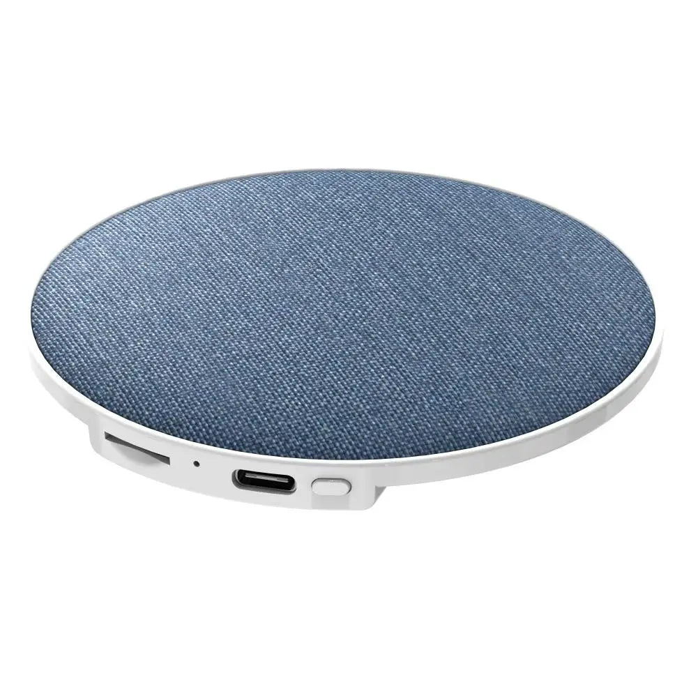 Circular wireless mini bedside pillow speaker with textured blue denim fabric top and surround sound bone conduction ports