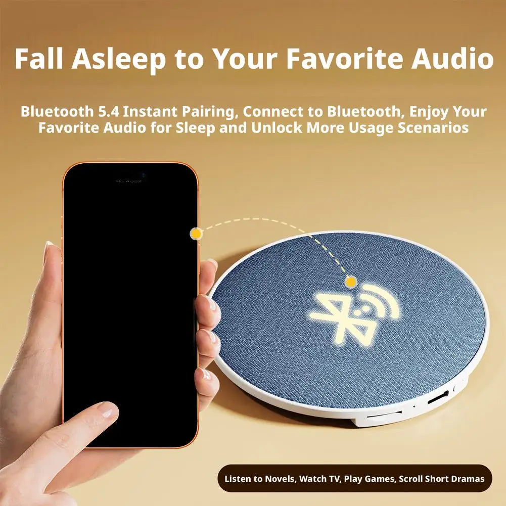 Blue denim textured circular under pillow speaker with white trim and glowing wireless symbol for surround sound bone conduction use