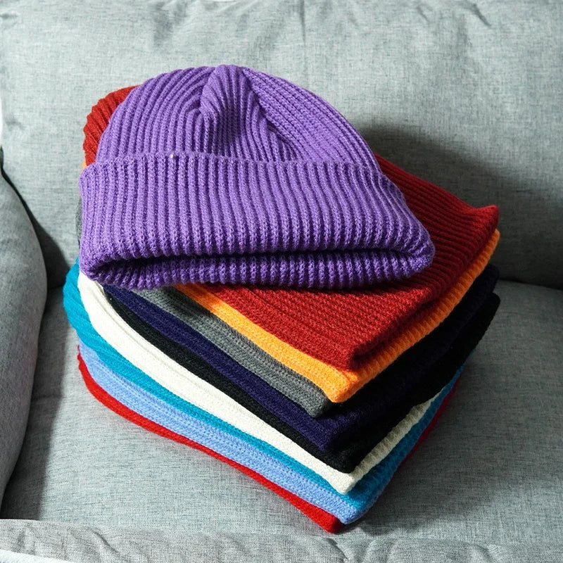 A vibrant purple warm knitted beanie made of female wool gorras stacked with colorful hip hop dad style beanies
