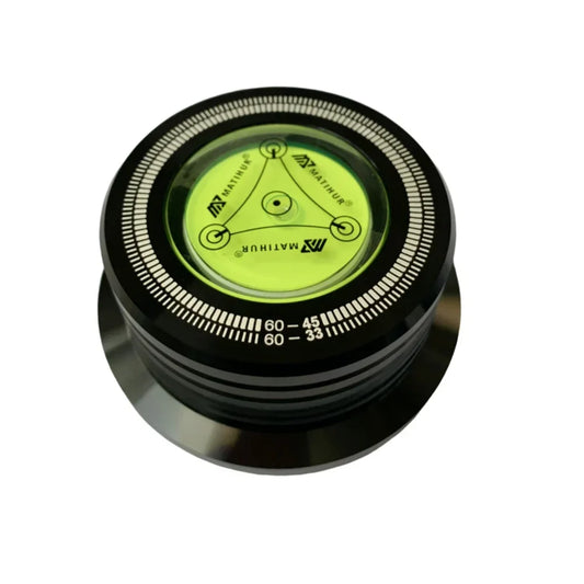 Black circular record stabilizer with bright green liquid bubble and white rim markings for 60hz lp vinyl alloy weight clamp