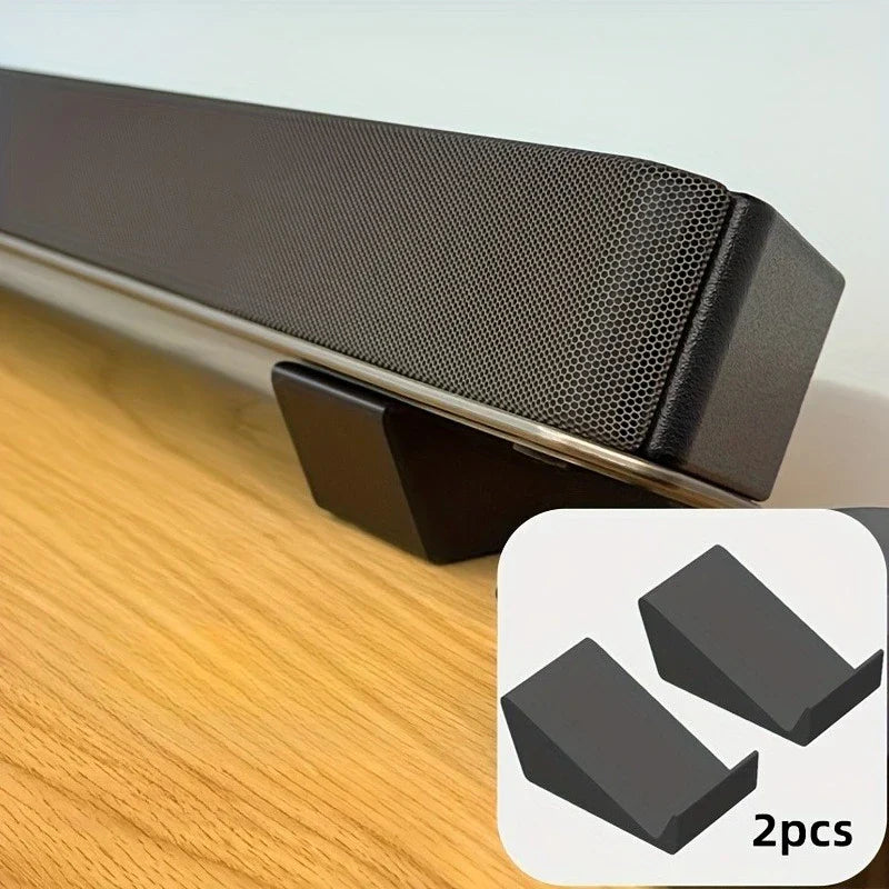 Black universal adjustable soundbar stand with textured perforated surface and sleek edges for home theater setup