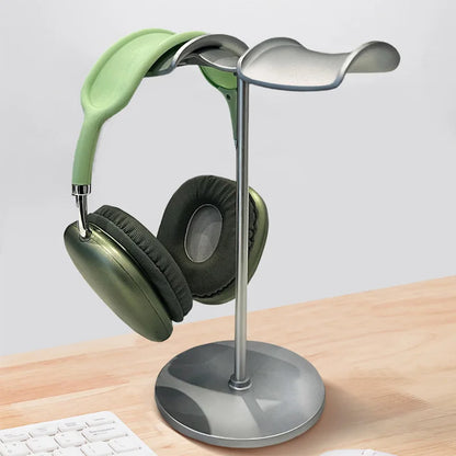 A sleek silver universal headphone stand with a curved top holding mint green over-ear headphones bracket display