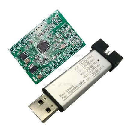 Silver usb adapter with black plastic ends and sigmastudio labeled pcb for dspmini learning board upgrades music experience adau1401