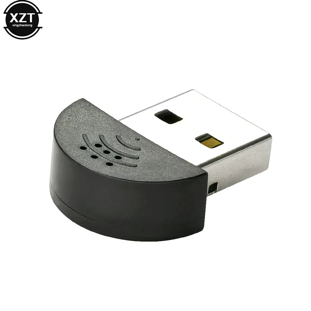 Black and silver usb 2.0 mic audio adapter with curved textured housing and speaker-like perforations for portable studio speech use