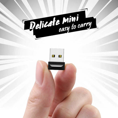 Black and silver metal usb 2.0 flash disk 16gb held between fingers highlighting compact pendrive external storage size