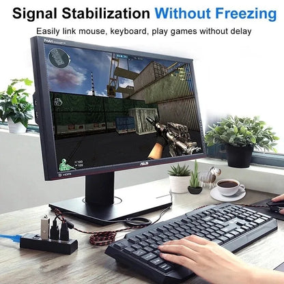 Black asus monitor displaying fps game with signal stabilization above usb hub 7 port multi usb splitter for laptop macbook accessories