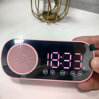 Pink and black mirror digital alarm clock with circular speaker grille and wireless speaker subwoofer for desktop music player