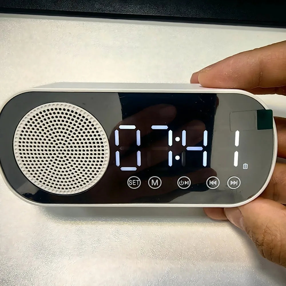 White mirror digital alarm clock with black display and circular speaker grille wireless speaker subwoofer desktop music player