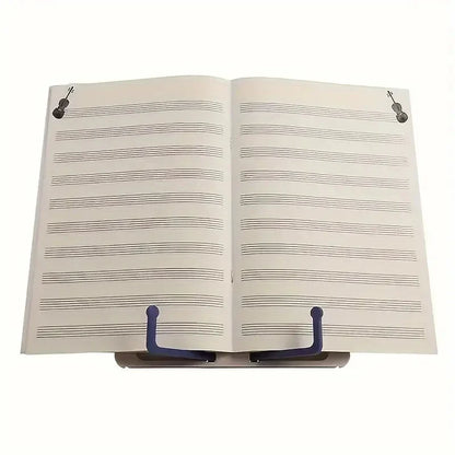 Open music book with black violin illustrations held by a blue adjustable music sheet stand for portable reading bookshelf use