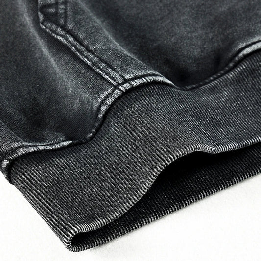 Black denim jacket with ribbed cuffs and visible stitching paired with vintage black hoodie and harajuku oversize hoodie styles