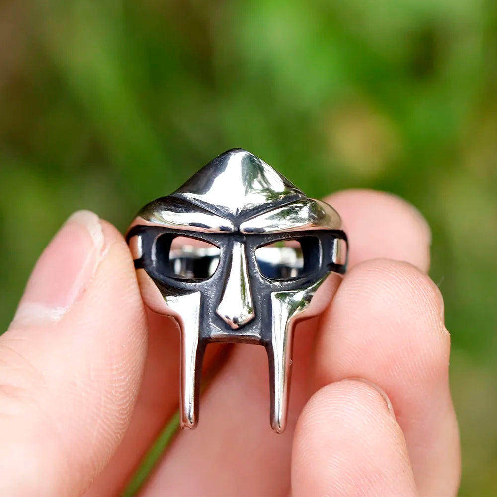 A shiny silver stainless steel doom mask ring with black accents featuring a vintage classic goth boys punk egyptian design