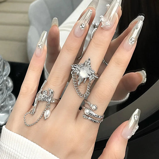 Silver gothic-style couple rings y2k with intricate winged design moonstone gem and dangling chain detail