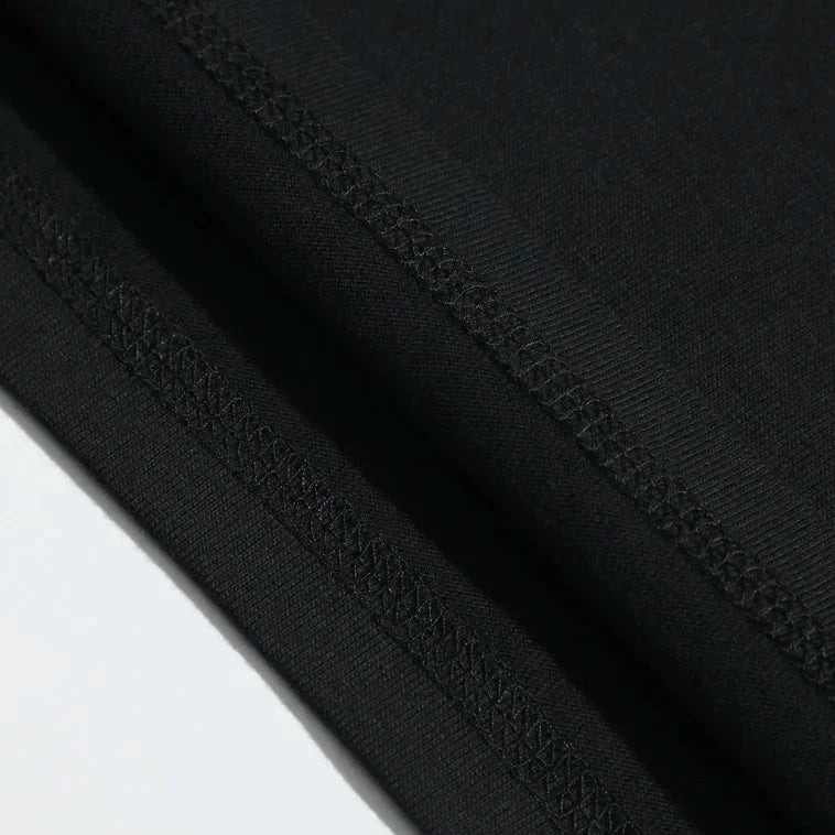 Black fabric with smooth texture and stitched seams on a vintage phantom opera 90s musical washed stretched streetwear t shirt
