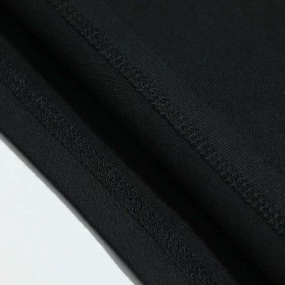 Black fabric with smooth texture and stitched seams on a vintage phantom opera 90s musical washed stretched streetwear t shirt