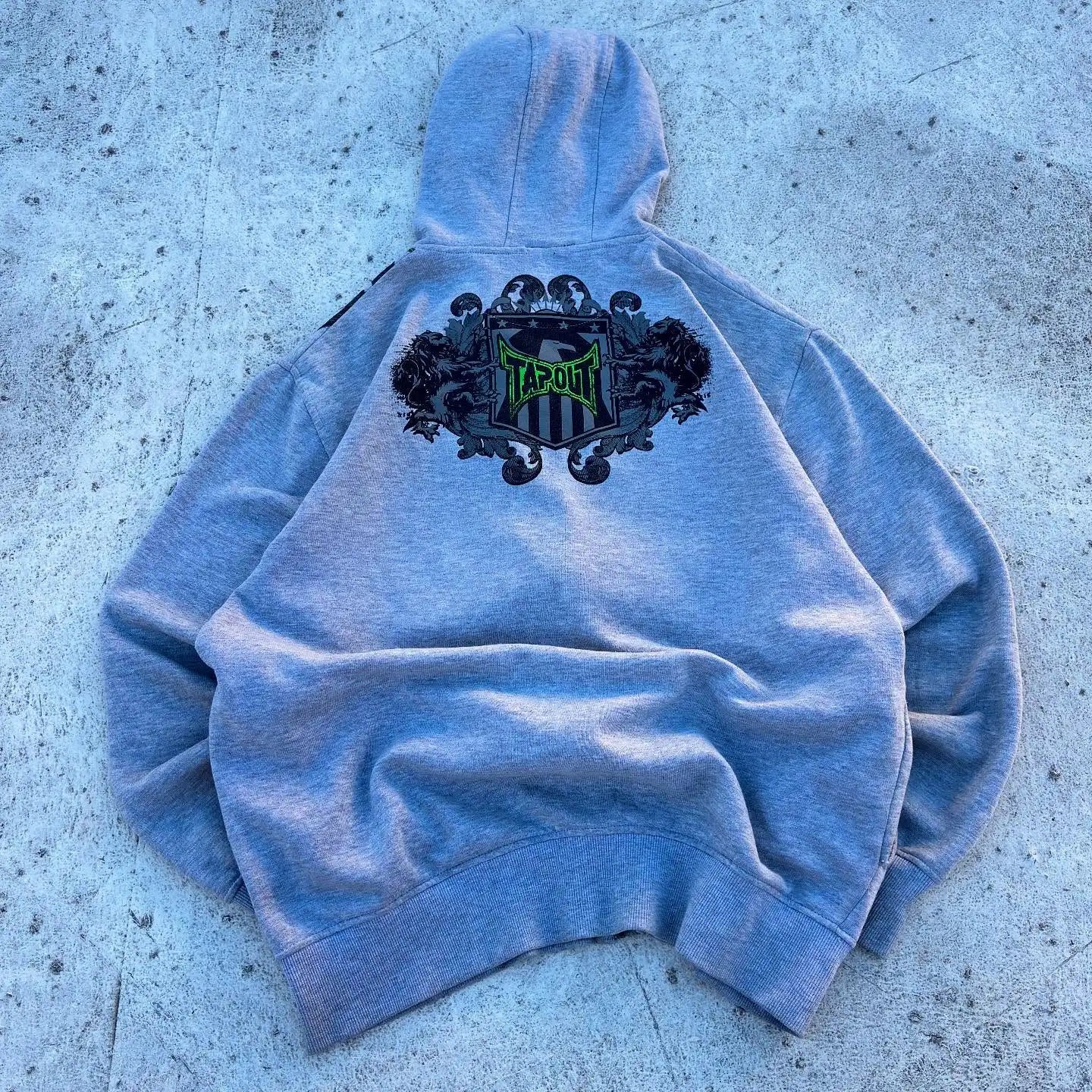 Back side of gray heathered vintage tapout graphic print zipper hoodie with black and green hop letter y2k logo embroidery