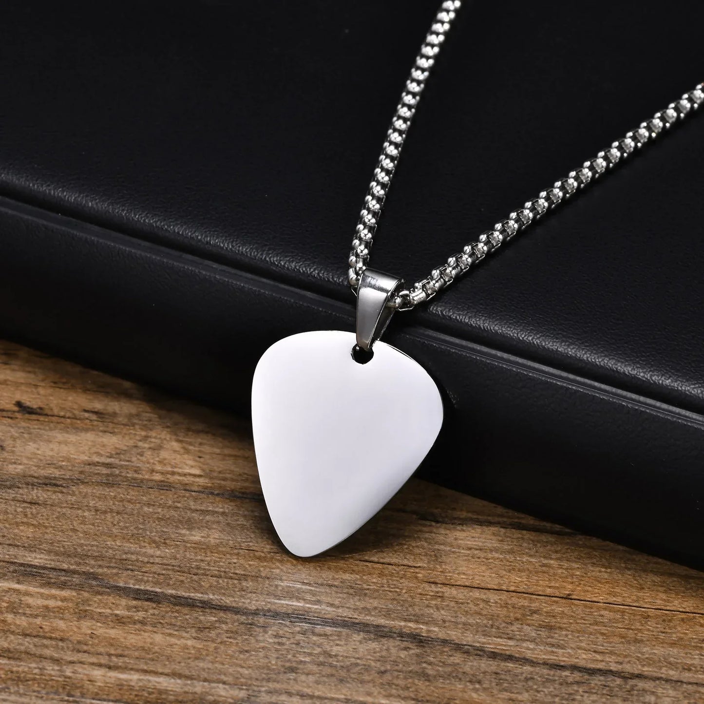 Silver unique guitar pick necklace on a stainless steel chain designed for music lovers and men boys gifting