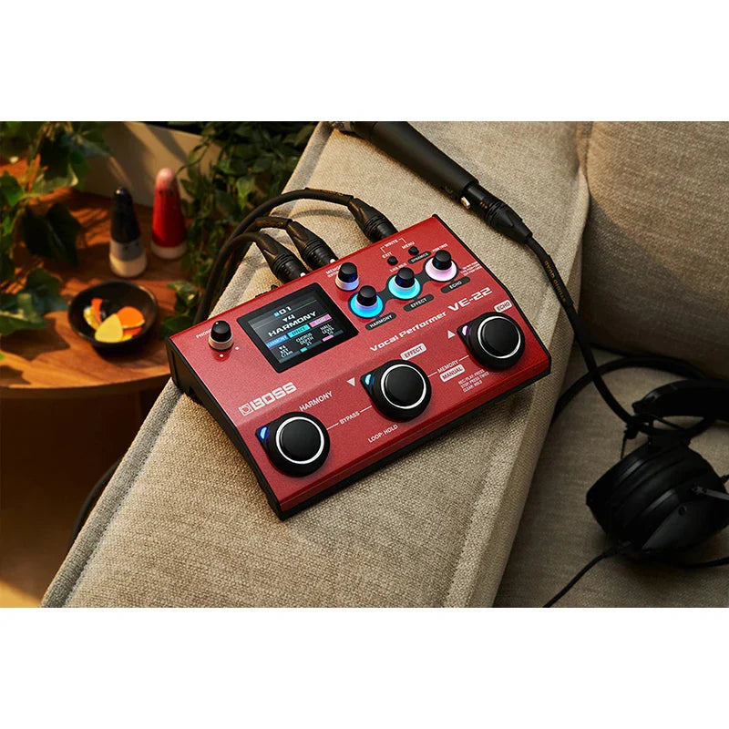 Red boss ve-22 vocal effects pedal with black knobs and blue backlighting features aux input and phantom power for mobile device use
