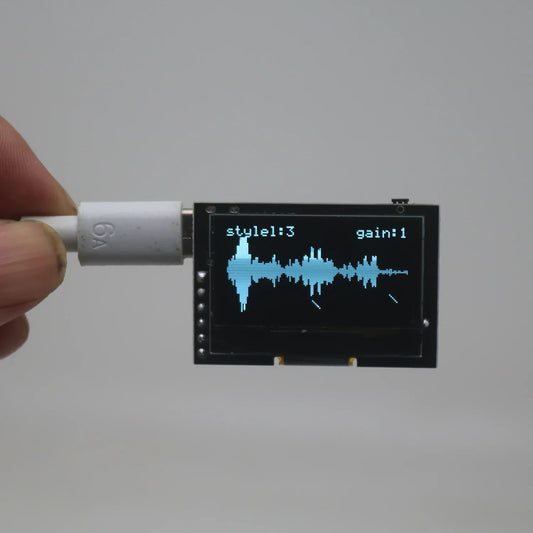 A compact black oled music spectrum display analyzer showing a blue audio waveform with type-c usb power supply ambient lights