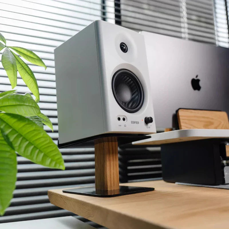 White edifier speaker displayed on a walnut oak wood speaker stand with a metal base modern desk organizer