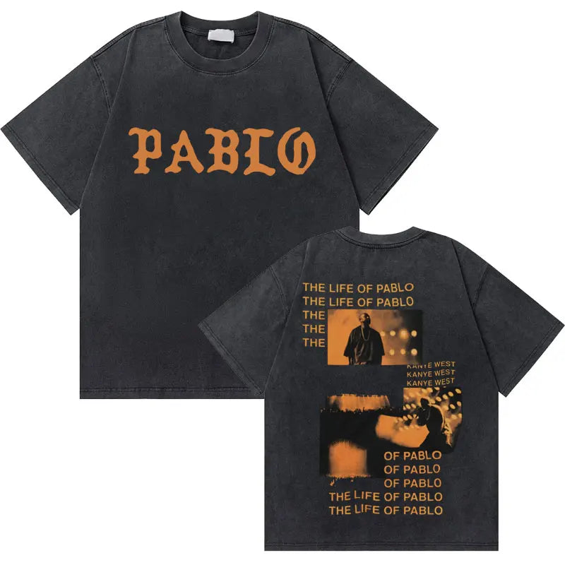 Black cotton t-shirt with orange pablo lettering and west graduation bear graphic on back in hip hop fashion oversized style