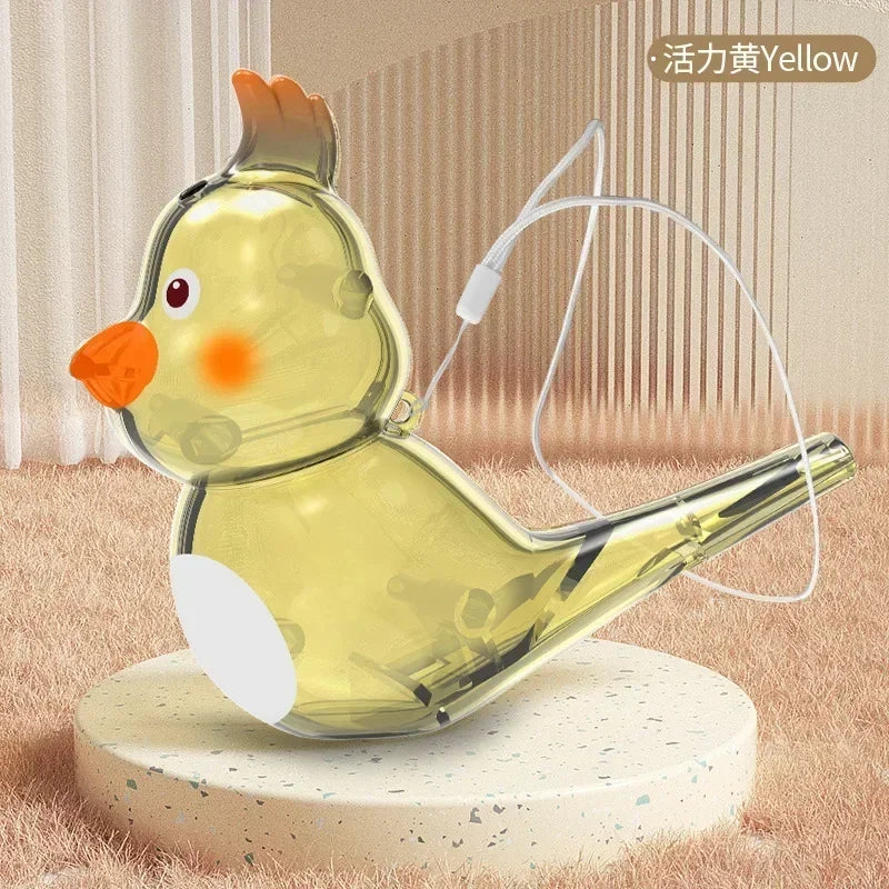 A translucent yellow plastic bird whistle children toy with orange beak for oral muscle pronunciation training