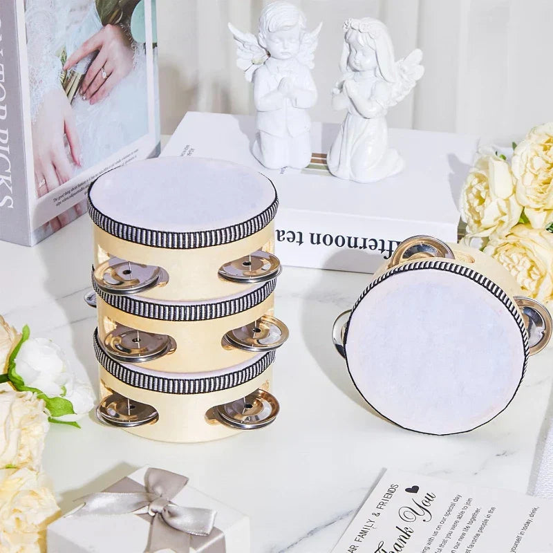 Cream-colored wedding tambourine drum with black and white striped trim and metallic jingles for percussion gift wood