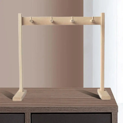 Light-colored wooden wind chime stand with four hooks for easy assembly chime and gong stand use in tabletop settings