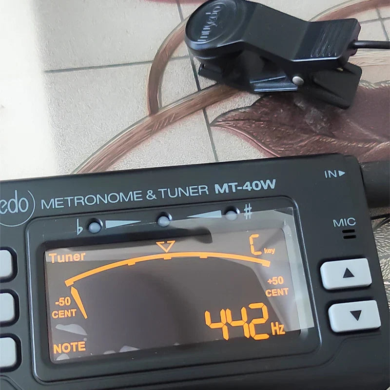 Black edo mt-40w wind instrument tuner with pickup clip dual mode and switchable metronome mode showing 442 hz display