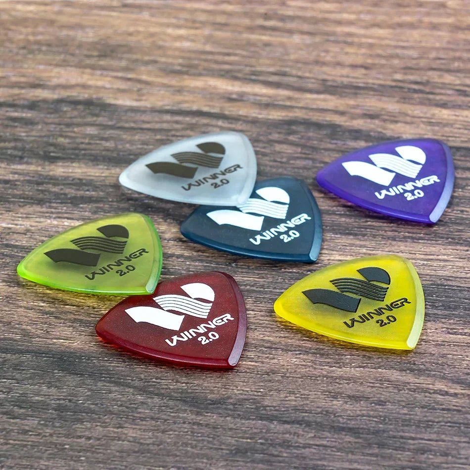 Set of six translucent colorful winner hybrid polycarbon guitar picks in vibrant shades for acoustic electric guitar use with box guitar accessories