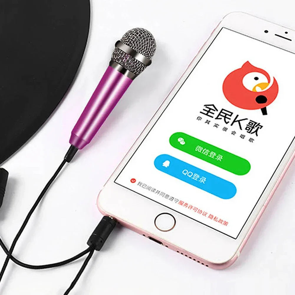 A vibrant purple wired 3.5mm stereo studio microphone earphone ktv karaoke mini microfon connected to a smartphone