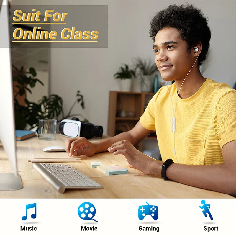 A young man wearing yellow type c in-ear wired earphones with hifi 6d surround bass seated at a desk with computer