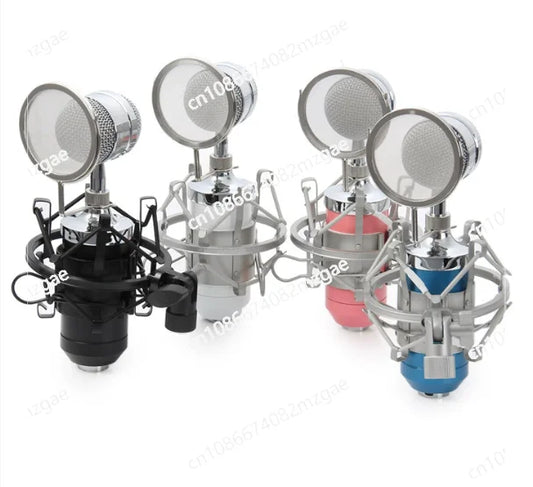 Set of four wired microphones recording with chrome finishes and colorful black silver pink and blue bases for broadcast use