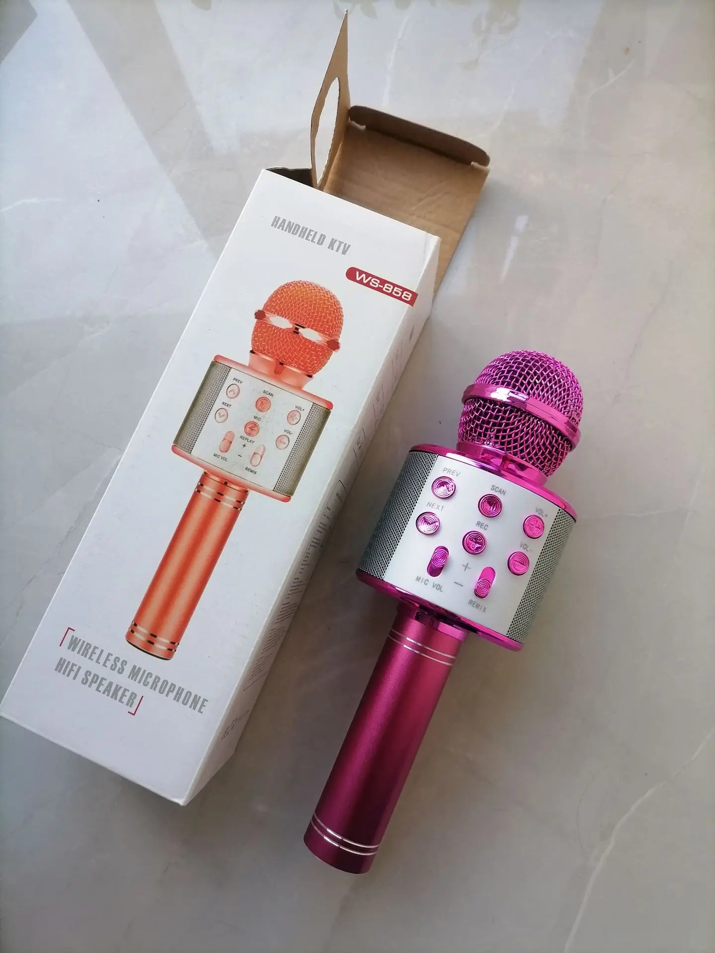 Pink wireless bluetooth k12 microphone with mesh grille and silver control panel for adults karaoke and portable party use