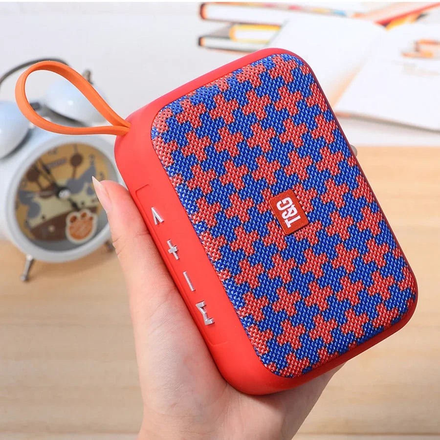 Red and blue houndstooth wireless bluetooth speaker with orange loop featuring radio fm waterproof and small subwoofer sound