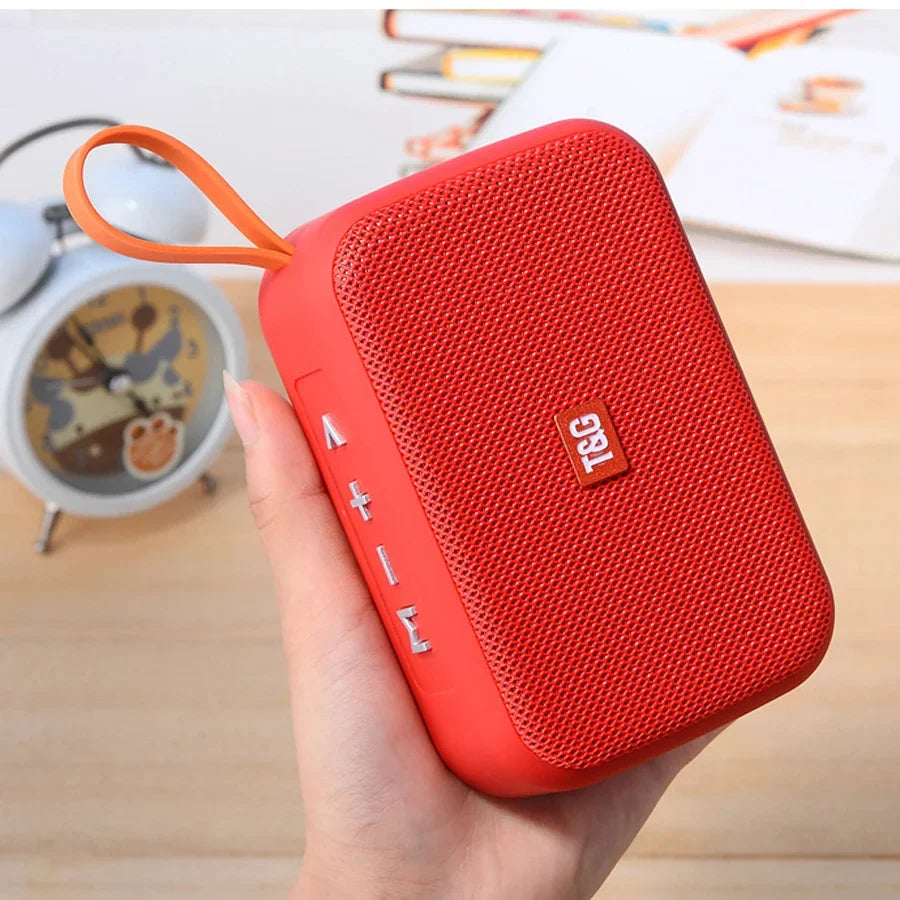 Red rectangular wireless bluetooth speaker with textured surface, orange loop, silver buttons, radio fm waterproof small subwoofer sound