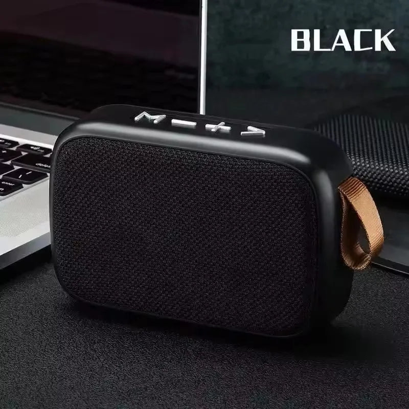 Black wireless mini bluetooth speaker with textured fabric grille silver buttons and tan strap designed for outdoor use