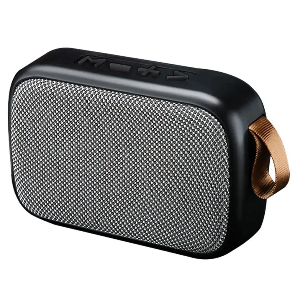 Black wireless mini bluetooth speaker with textured silver grille and tan fabric strap designed for outdoor use