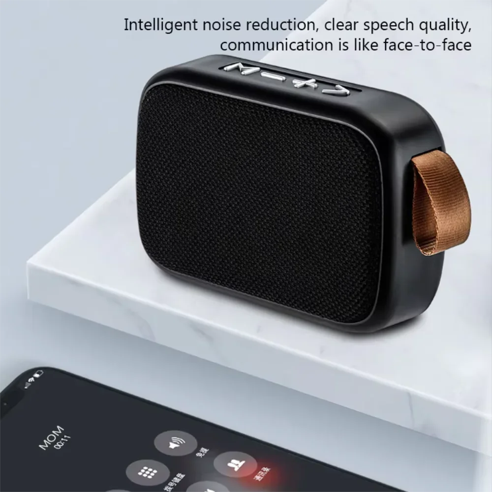 Black rectangular wireless mini bluetooth speaker with fabric grille metallic buttons and brown leather strap for outdoor use