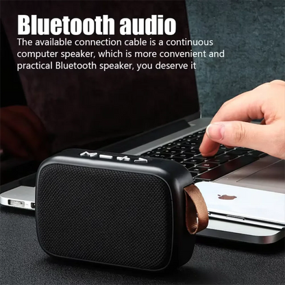 Black rectangular wireless mini bluetooth speaker with textured fabric grille and brown leather strap for outdoor use