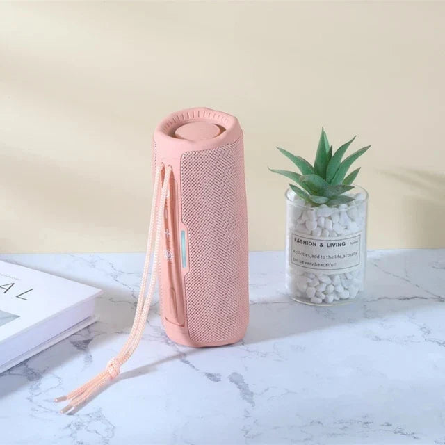 Pink wireless portable bluetooth speaker with mesh grille and carrying strap for radio fm subwoofer and audio hand free use